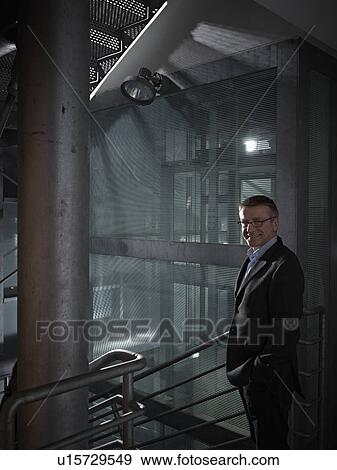 Business man leaving the office late View Large Photo Image Stock Photo - Business man leaving the office late. Fotosearch