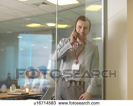 Stock Image - Business man on mobile. Fotosearch