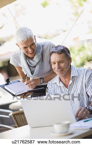 Business people using laptop outdoors View Large Photo Image Stock Photo - Business people using laptop outdoors. Fotosearch