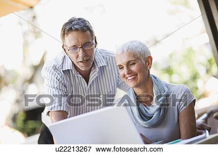 Stock Photo - Business people using laptop outdoors. Fotosearch
