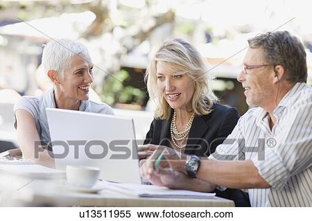 Business people using laptop outdoors View Large Photo Image Stock Photography - Business people using laptop outdoors. Fotosearch