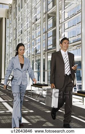 Business people walking down a corridor View Large Photo Image Stock Photograph - Business people walking down a corridor. Fotosearch