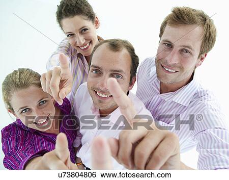 Stock Photograph - Business team point at camera. Fotosearch