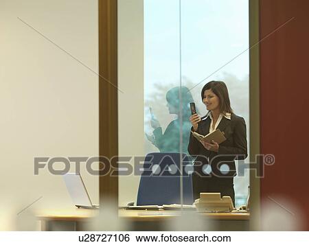 Business woman dialing mobile View Large Photo Image Stock Photograph - Business woman dialing mobile. Fotosearch