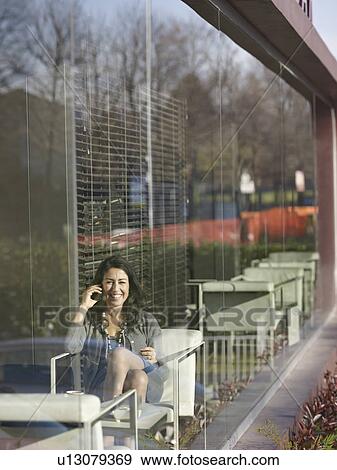 Stock Photo - Business Woman in Cafe on the phone. Fotosearch