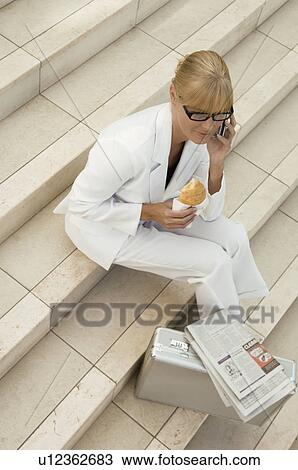 Business woman on the phone with pastry View Large Photo Image Stock Image - Business woman on the phone with pastry. Fotosearch