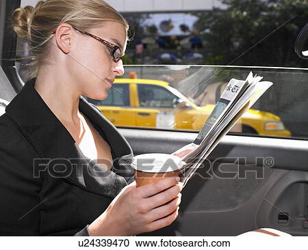 Business woman reading news paper in cab View Large Photo Image Stock Image - Business woman reading news paper in cab. Fotosearch