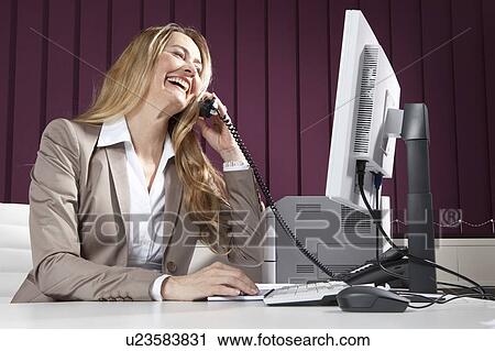 Business woman talking on phone View Large Photo Image Stock Image - Business woman talking on phone. Fotosearch