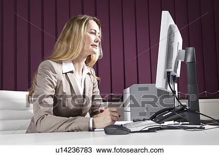 Business woman using desktop computer View Large Photo Image Stock Image - Business woman using desktop computer. Fotosearch
