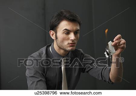 Stock Photograph - Businessman burning paper. Fotosearch