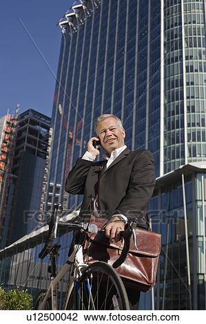 Businessman commuting on bicycle View Large Photo Image Stock Image - Businessman commuting on bicycle. Fotosearch