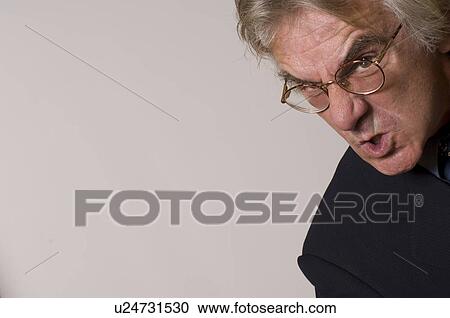Stock Image - Businessman grimacing. Fotosearch
