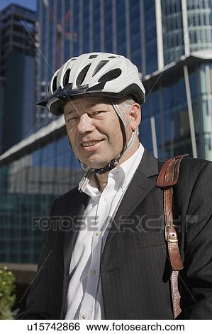 Businessman in bicycle helmet View Large Photo Image Stock Photograph - Businessman in bicycle helmet. Fotosearch