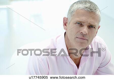 Stock Photography - Businessman in light office. Fotosearch