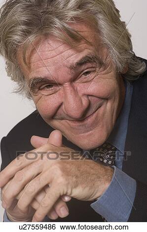 Businessman smiling with hands clasped View Large Photo Image Stock Photograph - Businessman smiling with hands clasped. Fotosearch