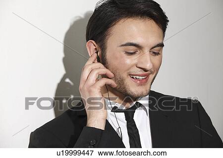 Businessman talking on headset View Large Photo Image Stock Photo - Businessman talking on headset. Fotosearch