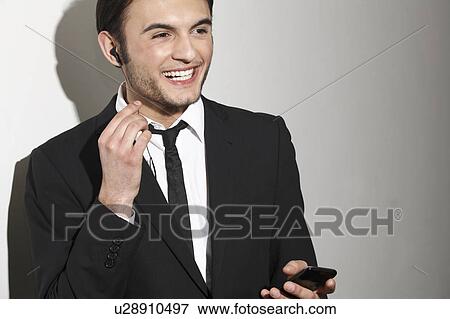 Businessman talking on headset View Large Photo Image Stock Photo - Businessman talking on headset. Fotosearch