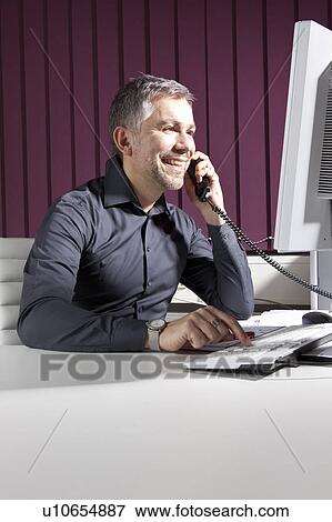 Businessman talking on phone View Large Photo Image Stock Photo - Businessman talking on phone. Fotosearch