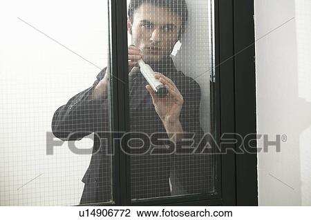 Businessman using telescope outside door View Large Photo Image Stock Image - Businessman using telescope outside door. Fotosearch
