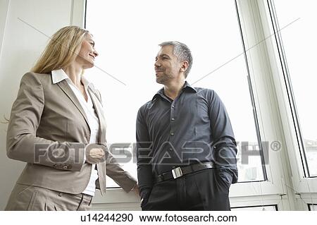 Businesspeople smiling at each other View Large Photo Image Stock Image - Businesspeople smiling at each other. Fotosearch