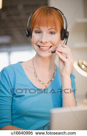 Businesswoman in headset using laptop View Large Photo Image Stock Photography - Businesswoman in headset using laptop. Fotosearch