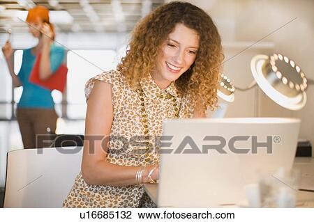 Businesswoman using laptop in office View Large Photo Image Stock Image - Businesswoman using laptop in office. Fotosearch