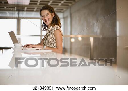 Stock Image - Businesswoman using laptop. Fotosearch