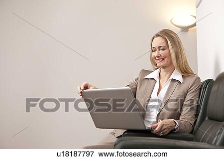 Stock Photo - Businesswoman using laptop. Fotosearch
