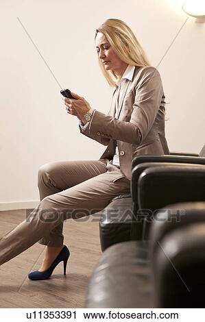 Stock Image - Businesswoman using mobile phone. Fotosearch