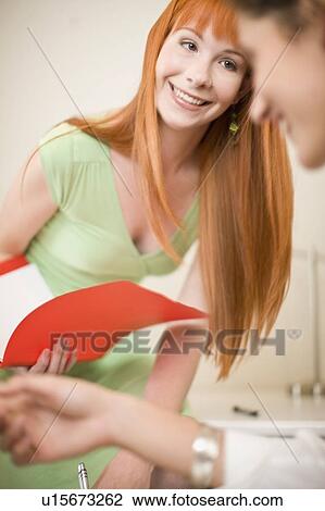 Businesswomen working together in office View Large Photo Image Stock Image - Businesswomen working together in office. Fotosearch
