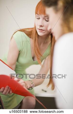 Businesswomen working together in office View Large Photo Image Stock Photo - Businesswomen working together in office. Fotosearch