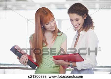 Businesswomen working together in office View Large Photo Image Stock Photo - Businesswomen working together in office. Fotosearch