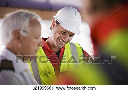 Captain and workers of a ship View Large Photo Image Stock Image - Captain and workers of a ship. Fotosearch