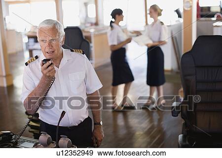 Captain doing a radio message View Large Photo Image Stock Photo - Captain doing a radio message. Fotosearch