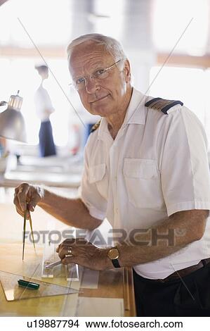 Picture - Captain setting the compasses. Fotosearch