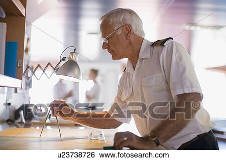 Captain setting the compasses View Large Photo Image Stock Photograph - Captain setting the compasses. Fotosearch