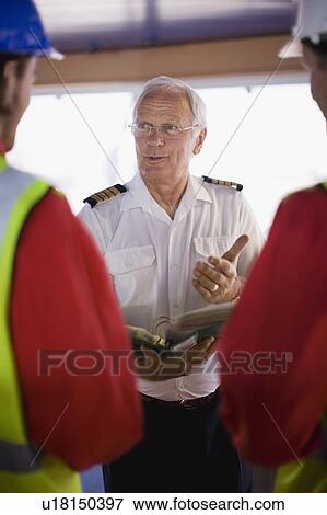 Stock Photo - Captain talking to workers. Fotosearch