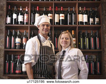 Chef and waitress standing with wine View Large Photo Image Stock Photography - Chef and waitress standing with wine. Fotosearch