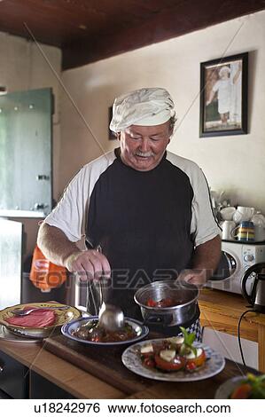 Stock Photograph - Chef arranging food. Fotosearch
