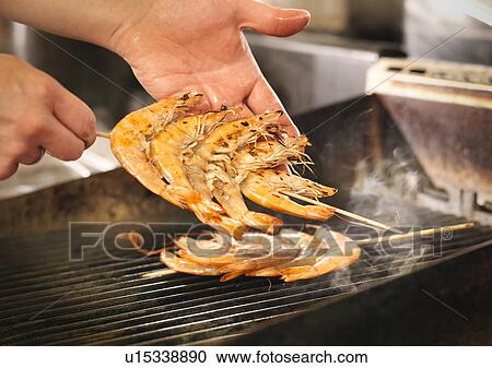 Chef cooking prawns on grill View Large Photo Image Stock Image - Chef cooking prawns on grill. Fotosearch