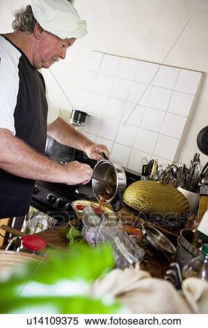 Chef effusing food View Large Photo Image Stock Photography - Chef effusing food. Fotosearch
