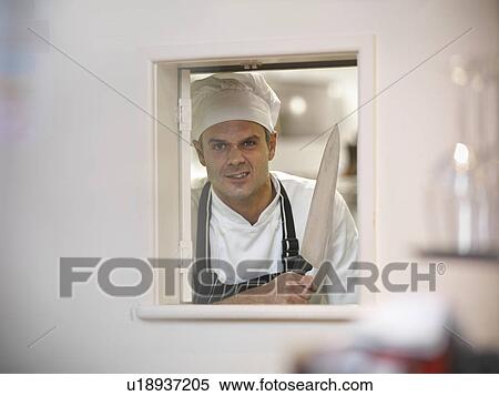 Chef holding large knife in restaurant View Large Photo Image Stock Photography - Chef holding large knife in restaurant. Fotosearch