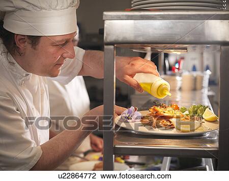Chef preparing plate of food View Large Photo Image Stock Image - Chef preparing plate of food. Fotosearch