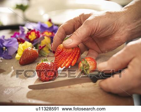 Stock Image - Chef slicing fruit . Fotosearch