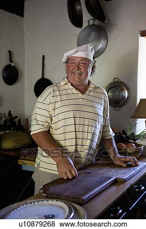 Chef smiling in kitchen View Large Photo Image Stock Photo - Chef smiling in kitchen. Fotosearch