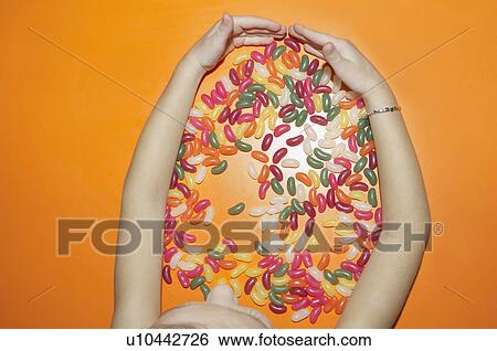 Stock Photograph - child grabbing sweets. Fotosearch