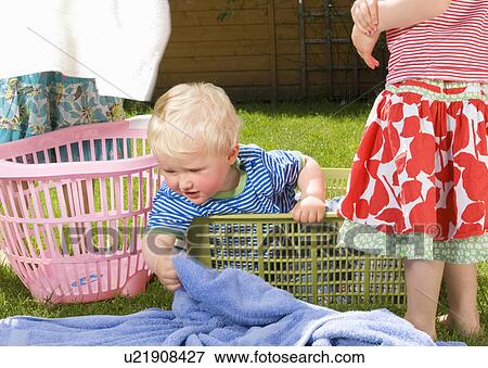 Stock Photo - children with laundry and wash baskets. Fotosearch