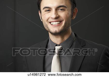 Stock Image - Close up of businessman smiling. Fotosearch