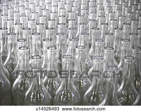 Stock Image - Close up of empty bottles in plant. Fotosearch
