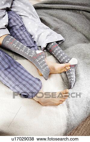 Close up of feet of couple cuddling up View Large Photo Image Stock Photo - Close up of feet of couple cuddling up. Fotosearch